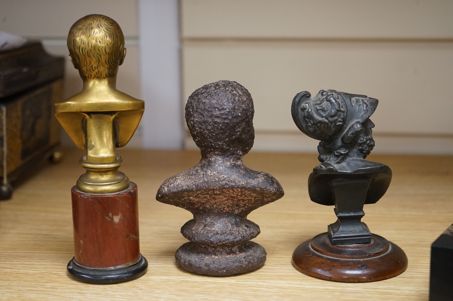 A bronze bust of Napoleon, a bust of Ajax and a cast iron bust of an Emperor, tallest 18cm